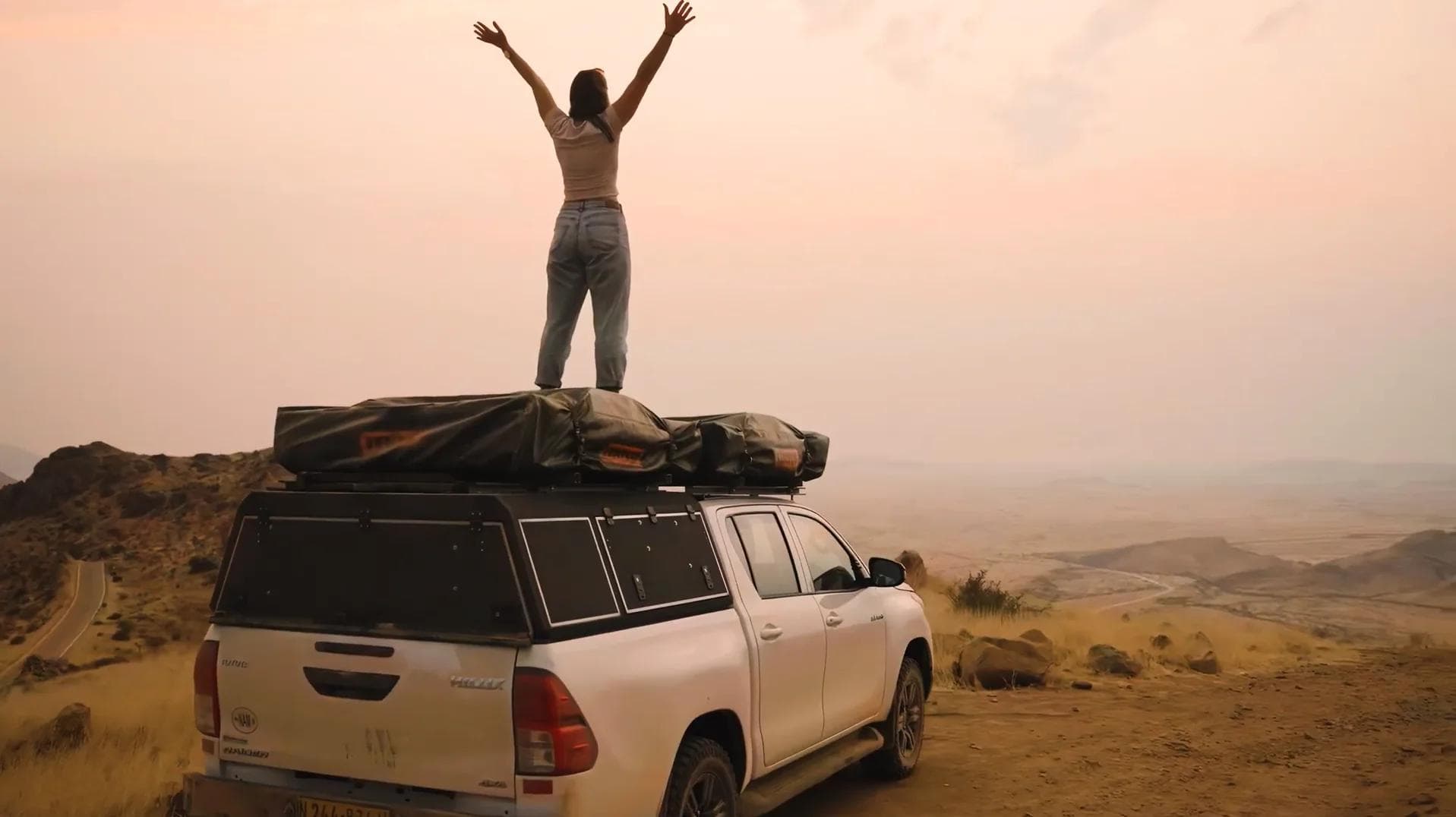 Lady standing on roof tent