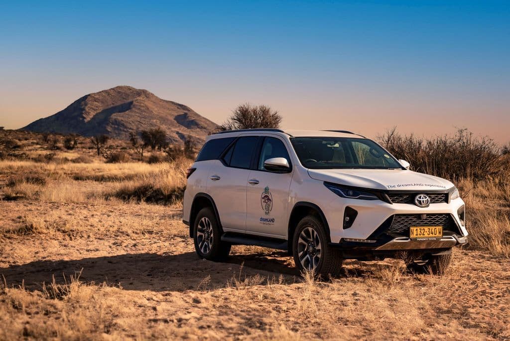 Rental car Namibia Toyota Fortuner in nature with mountain in the background